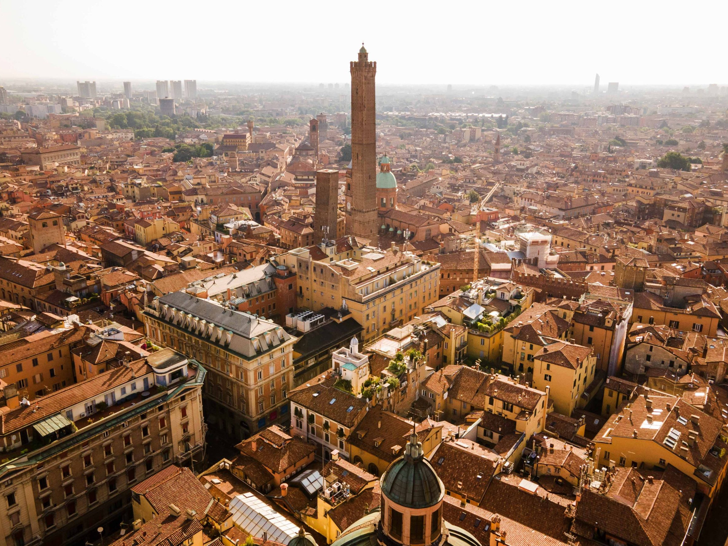 Aerial drone view of Bologna city and the two towers in the middle early in the morning, Italy